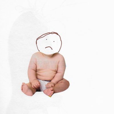 Baby with its head drawn on with a sad face