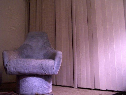 Gif of chair in front of blinds opening and closing