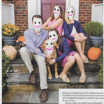 A family with happy faces drawn overtop of their conforming faces.